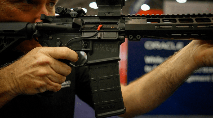 Laser Ammo Flash Bolt inserted into AR-style rifle with red laser module, showcasing drop-in bolt replacement for dry-fire training.