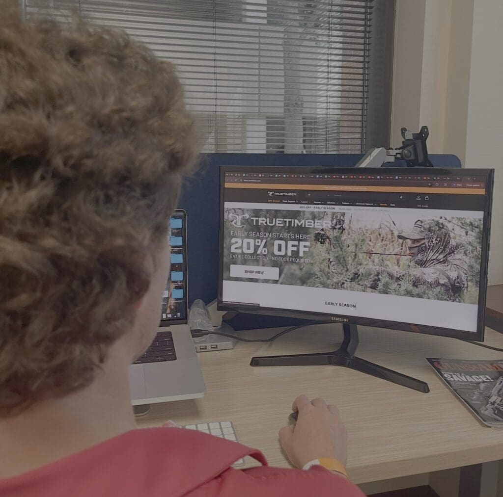Person on computer looking at a camo company