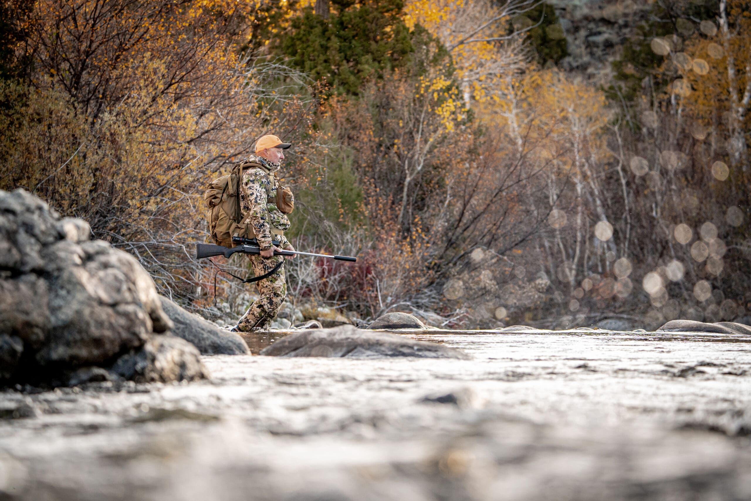 Hunter displaying harvested game, rifle, and Remington ammo for effectiveness outdoor marketing agency shoot