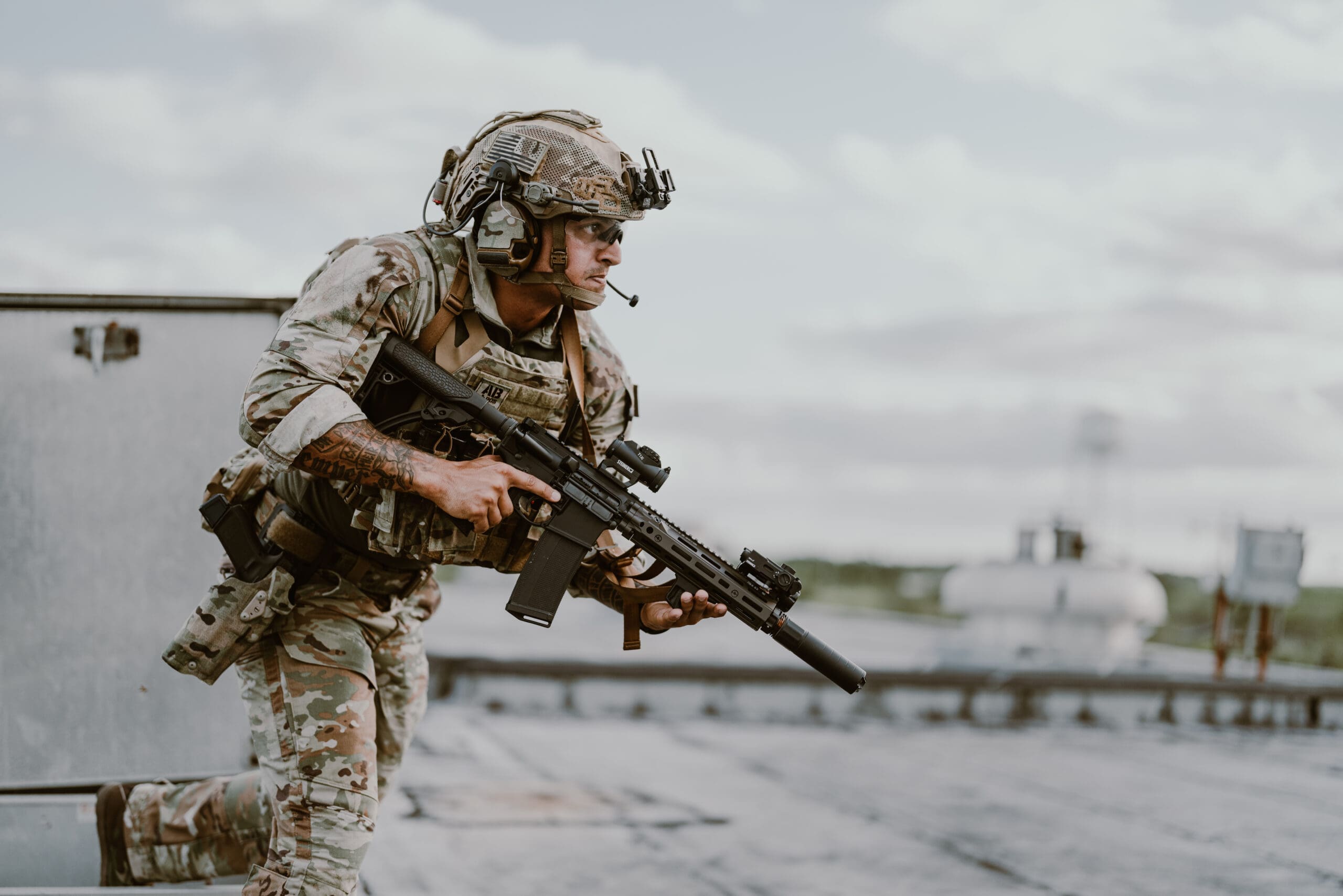 military man running with ar in full equipment 