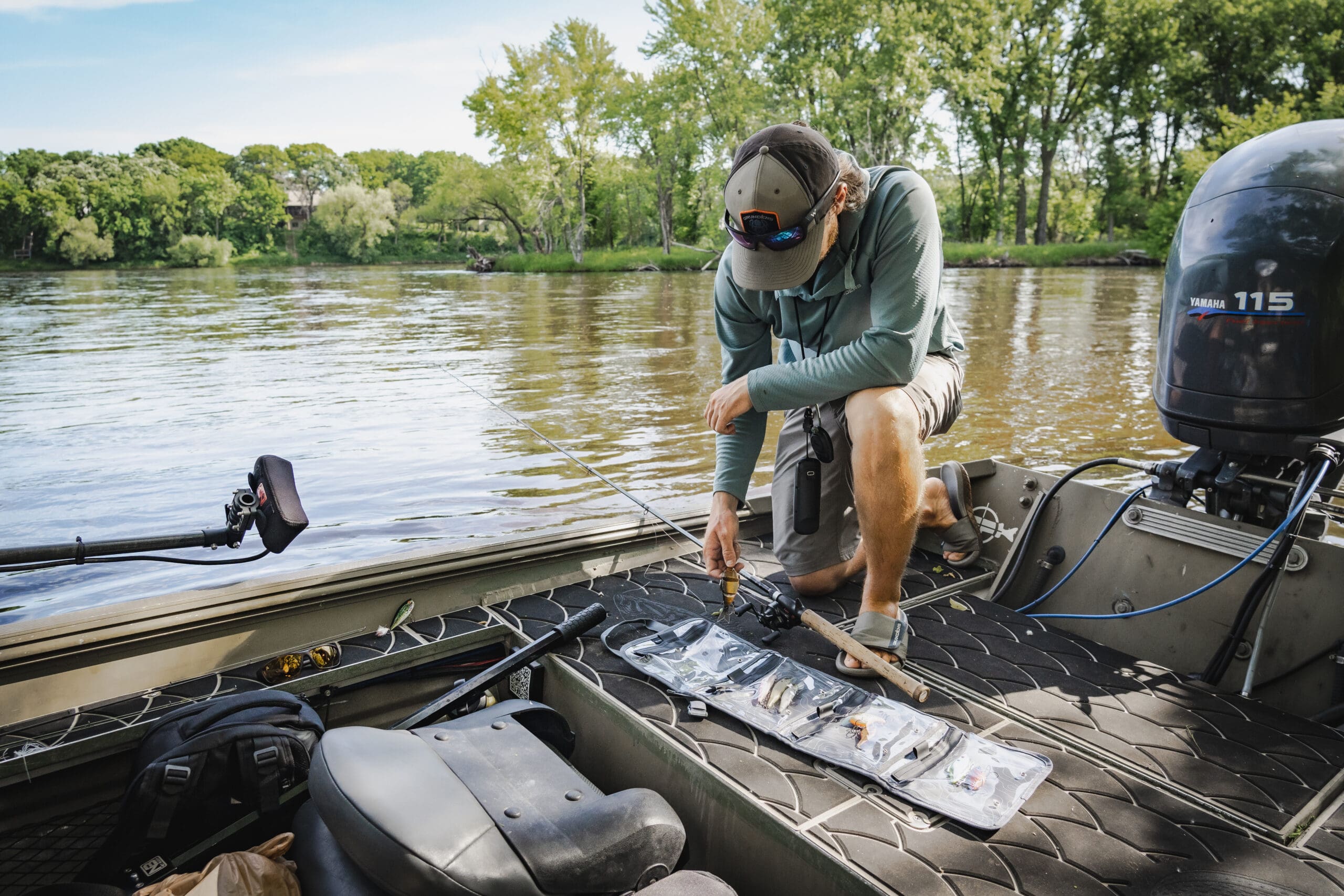 person on a boat with fishing pole