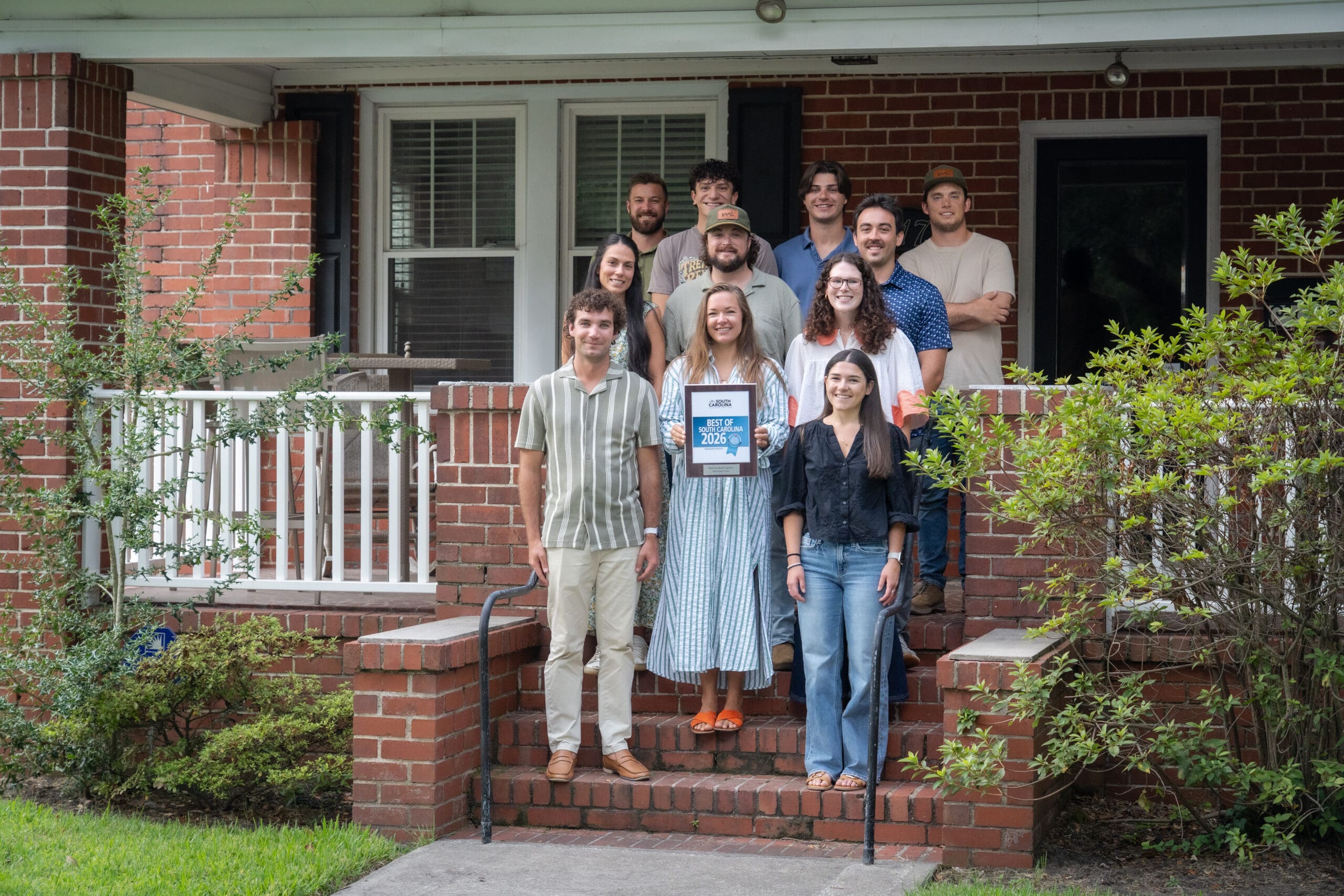 Murray road agency team recognized for best of south Carolina awards standing as a team in front of the office. 